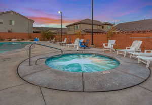 Community pool featuring a community hot tub, a patio, and a residential view