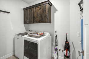 Laundry room with cabinet space and separate washer and dryer