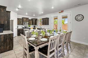 Dining space with light tile patterned flooring, french doors, and recessed lighting