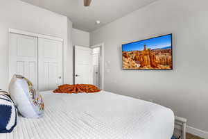 Bedroom with ceiling fan and a closet