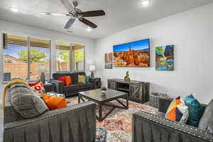 Living room featuring ceiling fan and recessed lighting