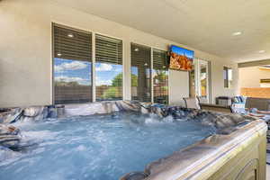 View of pool with a hot tub and patio surround