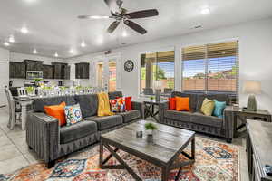 Living room featuring light tile patterned floors, recessed lighting, ceiling fan, and french doors