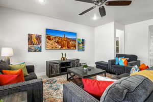 Living area featuring a ceiling fan and recessed lighting
