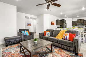 Living room featuring ceiling fan, light tile patterned floors, and recessed lighting