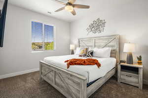 Bedroom with ceiling fan and dark carpet