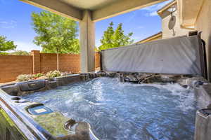 View of swimming pool featuring a hot tub and a fenced backyard