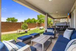 Fenced backyard featuring a patio area and outdoor lounge area