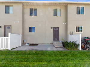 Rear view of house featuring stucco siding and a patio