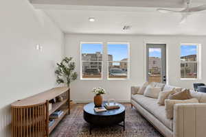 Living area with ceiling fan and wood finished floors