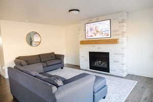 Living area featuring wood finished floors and a fireplace