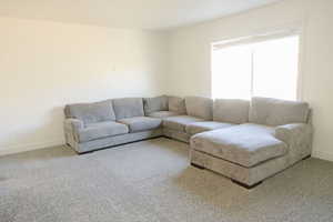 Living area with baseboards and carpet flooring