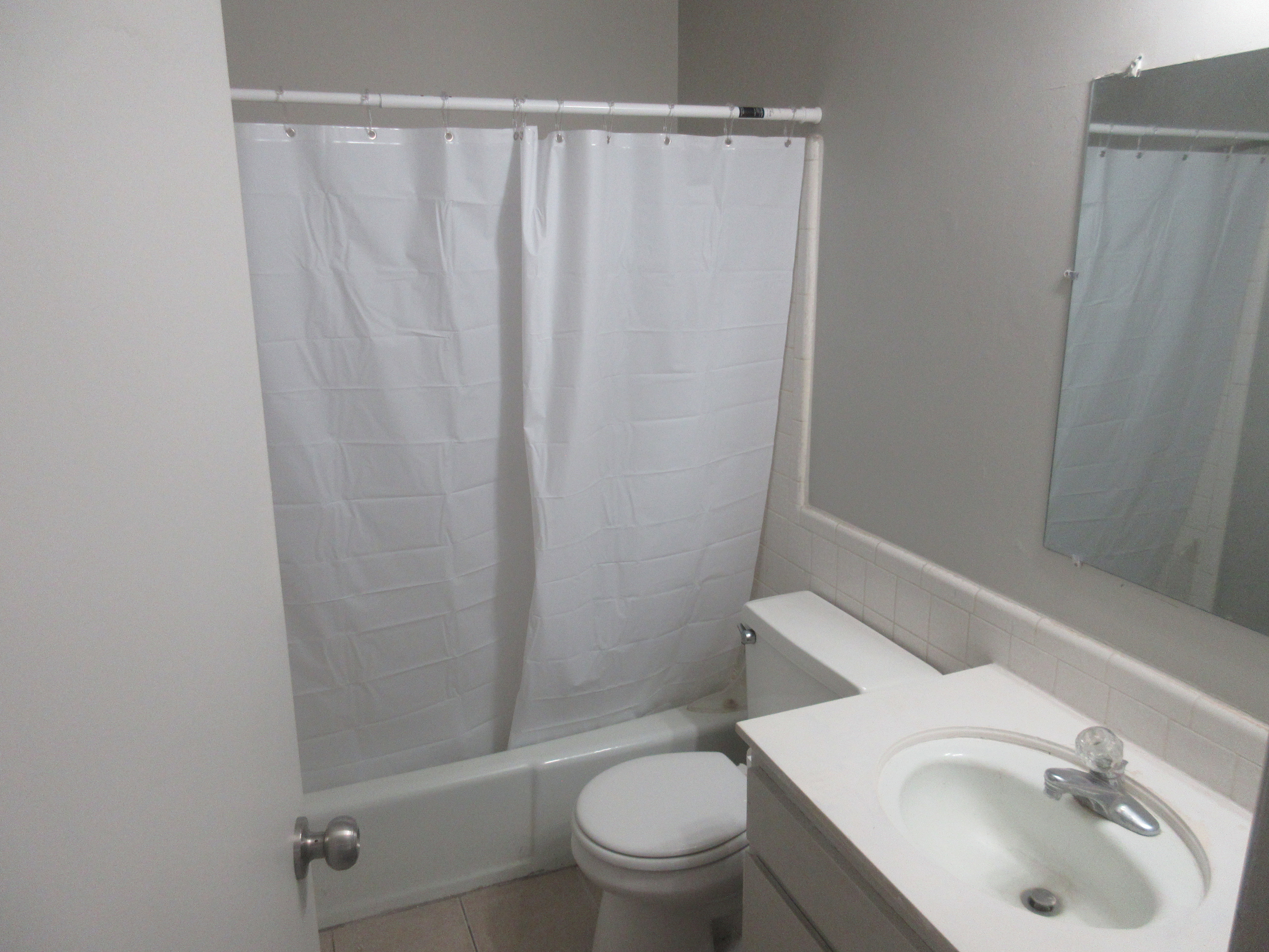 Full bathroom with vanity, shower / tub combo with curtain, and tile patterned floors