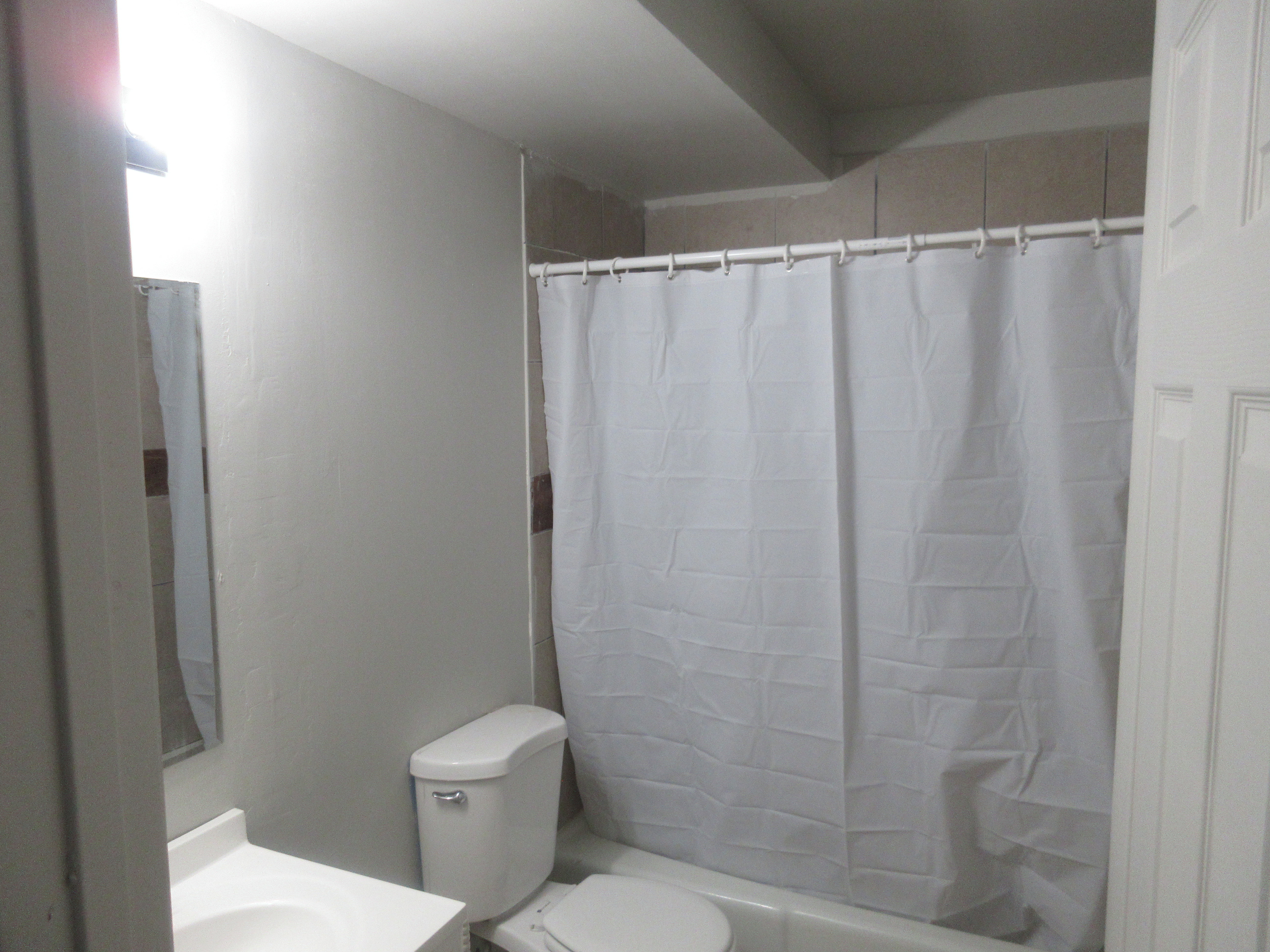 Bathroom with vanity and shower / tub combo
