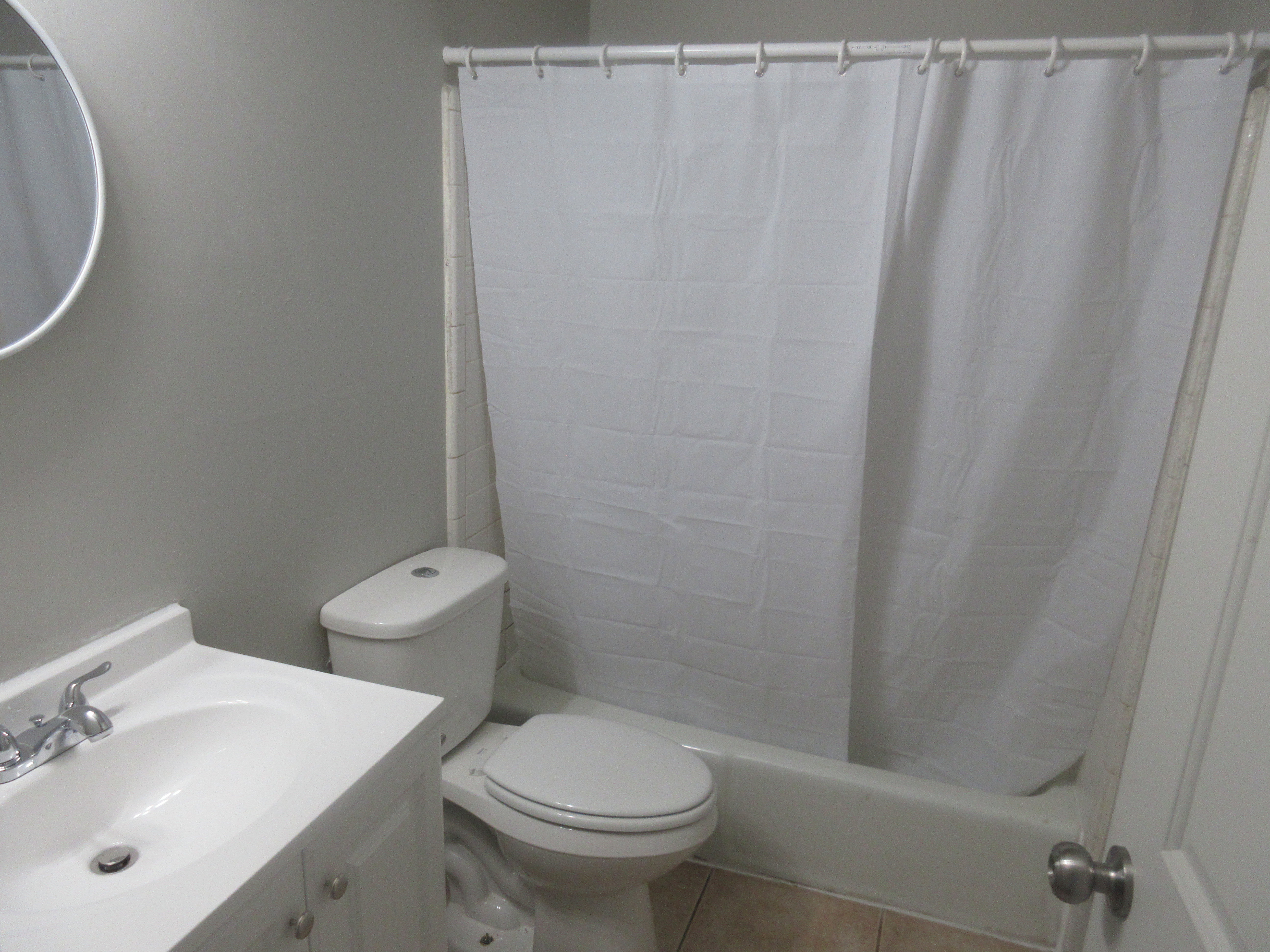 Full bath featuring vanity, tile patterned floors, and shower / bath combo