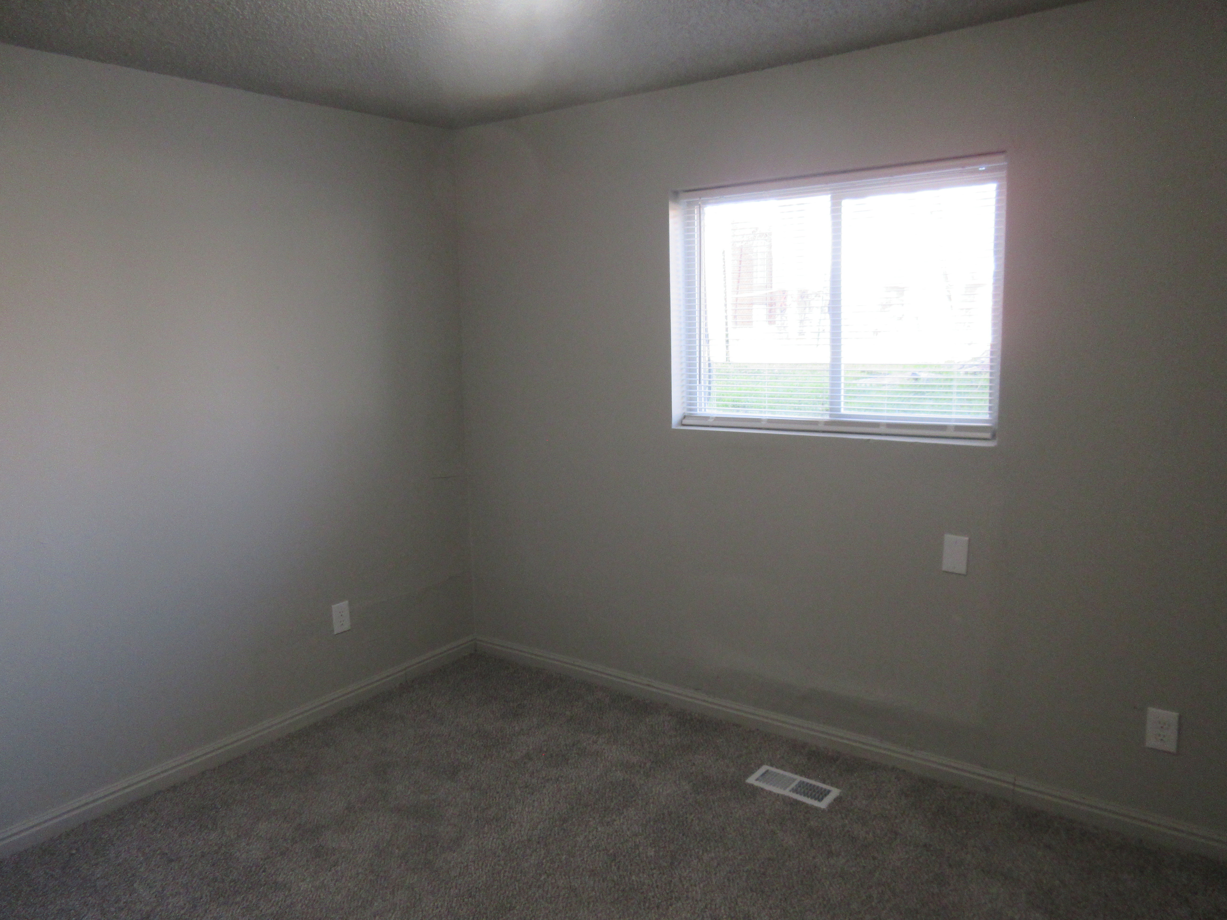 Unfurnished room with carpet floors and a textured ceiling