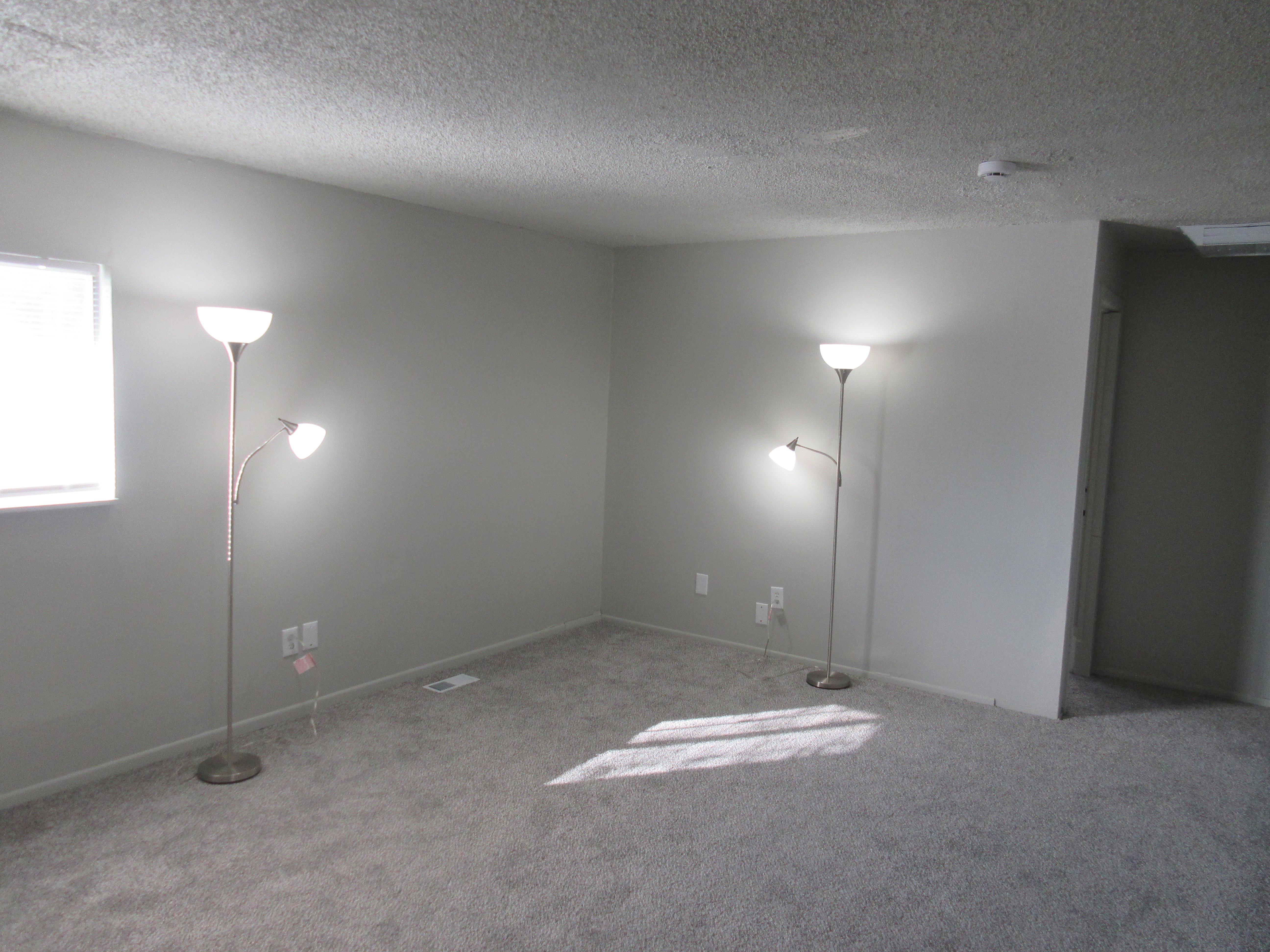 Empty room with carpet flooring and a textured ceiling