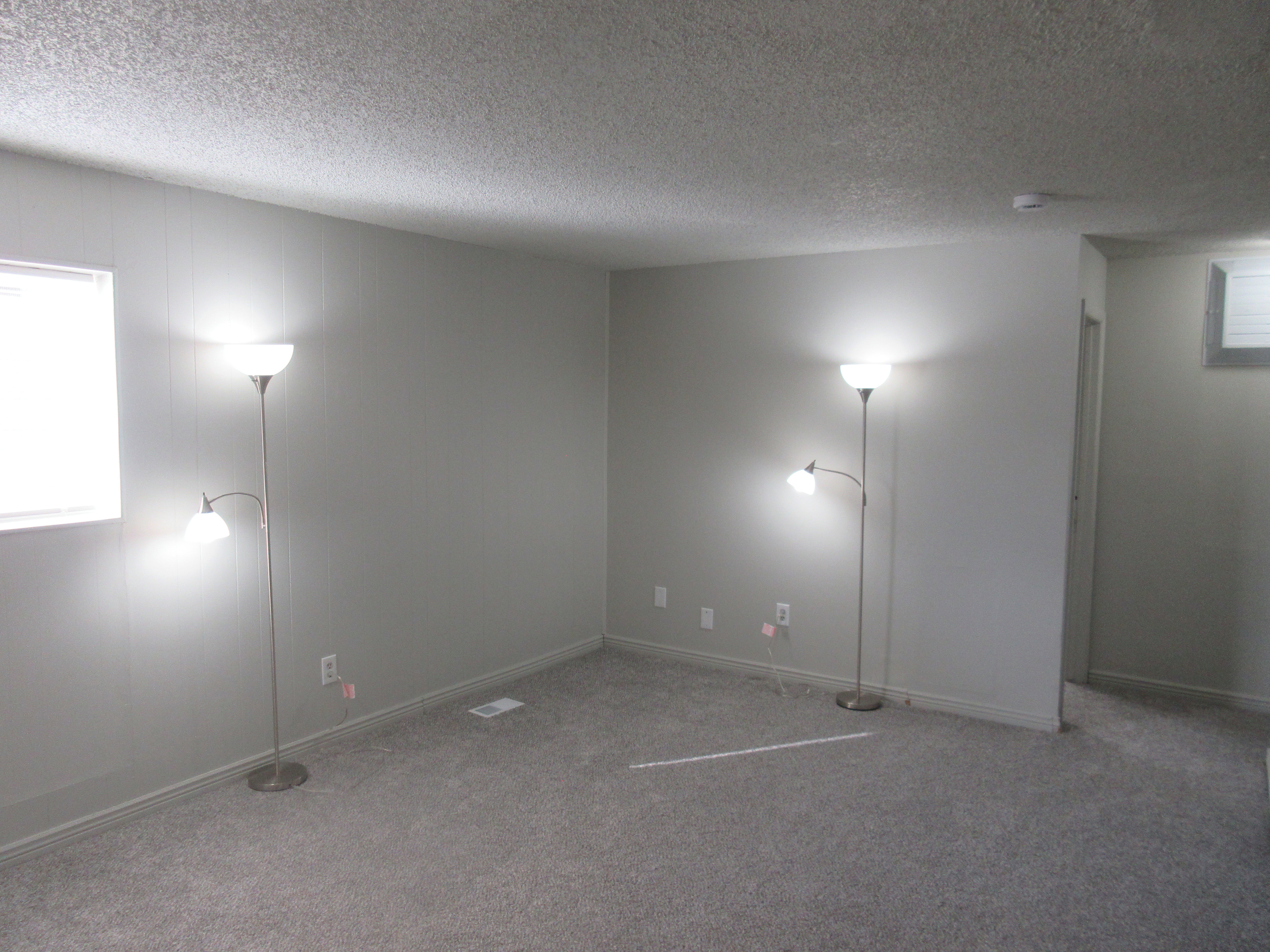 Spare room with carpet flooring and a textured ceiling