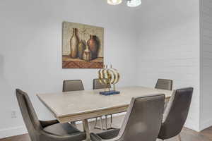 Tiled dining space featuring baseboards