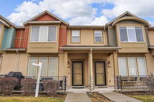 View of front of home with stucco siding and a porch