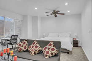 Bedroom with recessed lighting, light carpet, and a ceiling fan