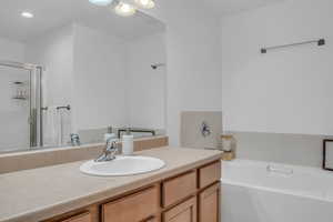 Full bathroom with a garden tub, vanity, and a shower stall