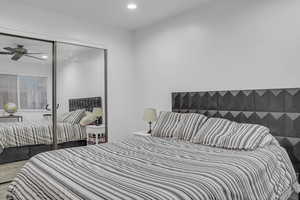 Bedroom featuring recessed lighting, carpet, and a closet