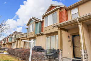Exterior space featuring stucco siding and a residential view