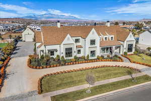 View of front of property featuring a chimney, roof with shingles, and a front yard