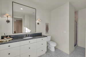 Full bath with a shower stall, vanity, and recessed lighting