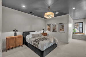 Bedroom with light colored carpet and recessed lighting