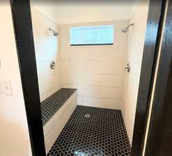Full bath with a stall shower and tile patterned flooring