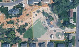 Aerial overview of property's location featuring property boundaries highlighted and nearby suburban area