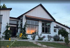View of front of home with board and batten siding and a standing seam roof