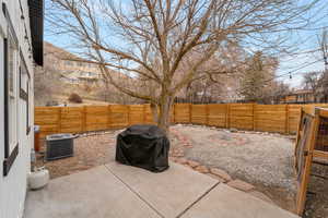 Fenced backyard with a grill and a patio area