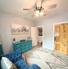 Living area with a ceiling fan and wood finished floors
