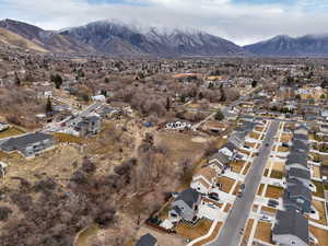 Aerial overview of property's location featuring nearby suburban area and a mountainous background