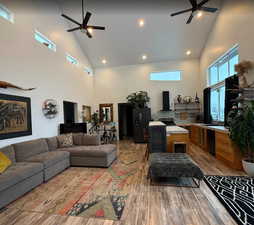 Living area with ceiling fan, lofted ceiling, light wood-style floors, and recessed lighting