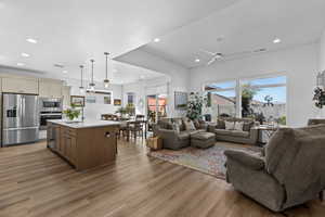 Living area with ceiling fan, light wood-type flooring, and recessed lighting