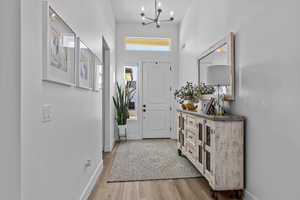 Foyer featuring a chandelier and light wood-style flooring