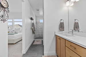 Ensuite bathroom with vanity and tiled shower