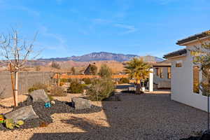 Fenced backyard featuring a mountain view