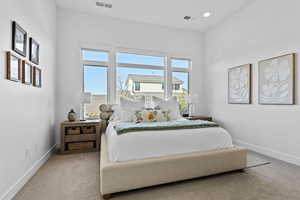 Carpeted bedroom with baseboards and recessed lighting