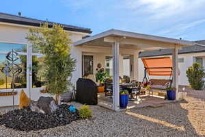 Rear view of house featuring a patio area and stucco siding