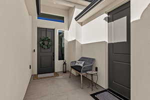 Entrance to property with stucco siding