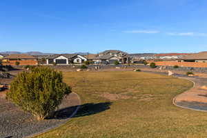 View of green lawn featuring a residential view and a mountain view