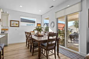 Dining area featuring light wood-type flooring and recessed lighting