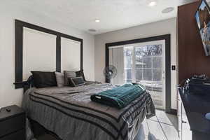 Bedroom with access to outside, recessed lighting, and a textured ceiling
