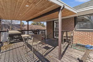 Wooden terrace featuring area for grilling