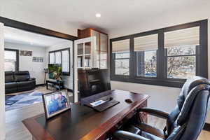 Office featuring light wood-type flooring and recessed lighting